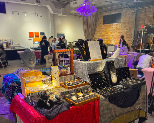 Jewelry display table with various items at an event. For the Love of Natural Living. FLNLiving